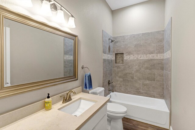 5128 Country Club Dr, Granbury, TX 76049 - bathroom featuring toilet, vanity,  shower combination, and wood finished floors