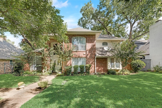 1412 Hyde Park Ln, Arlington, TX 76015 - view of front of property with a front yard, brick siding, and roof with shingles