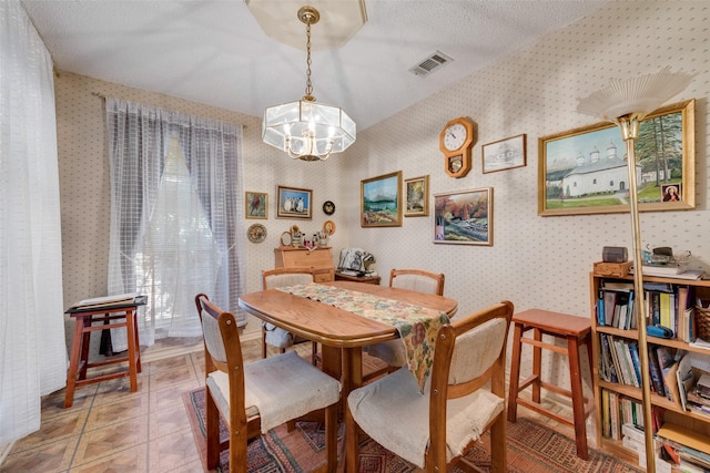 1412 Hyde Park Ln, Arlington, TX 76015 - dining area with wallpapered walls, a chandelier, and light tile patterned floors