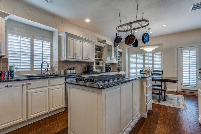 9808 Capilano Dr, Plano, TX 75025 - kitchen with a sink, open shelves, stainless steel gas stovetop, dark wood finished floors, and recessed lighting