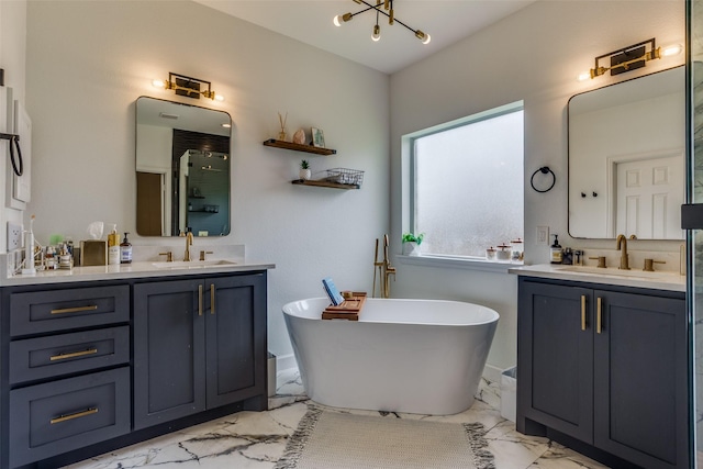 9808 Capilano Dr, Plano, TX 75025 - bathroom with marble look tile flooring, two vanities, and a soaking tub