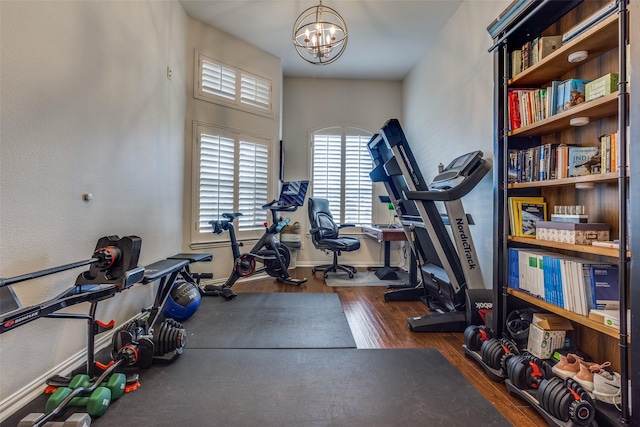 9808 Capilano Dr, Plano, TX 75025 - workout room with a chandelier, wood finished floors, and baseboards