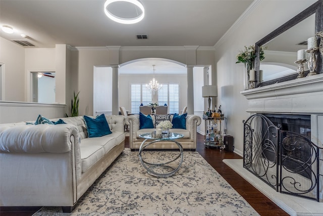 9808 Capilano Dr, Plano, TX 75025 - living area with ornate columns, arched walkways, ornamental molding, wood finished floors, and a fireplace with raised hearth