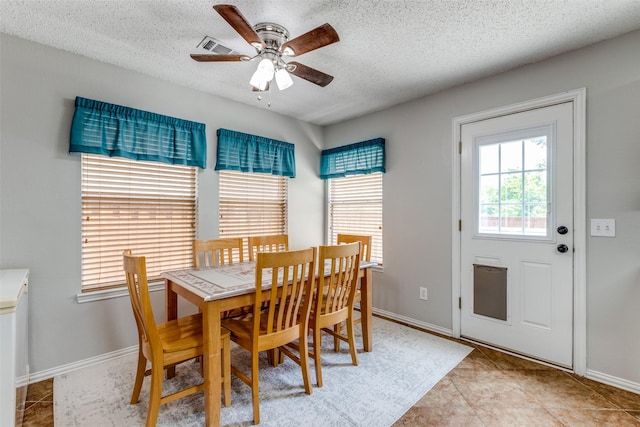 1017 Lake Trail Dr, Little Elm, TX 75068 - dining room featuring a textured ceiling, a ceiling fan, baseboards, and light tile patterned flooring