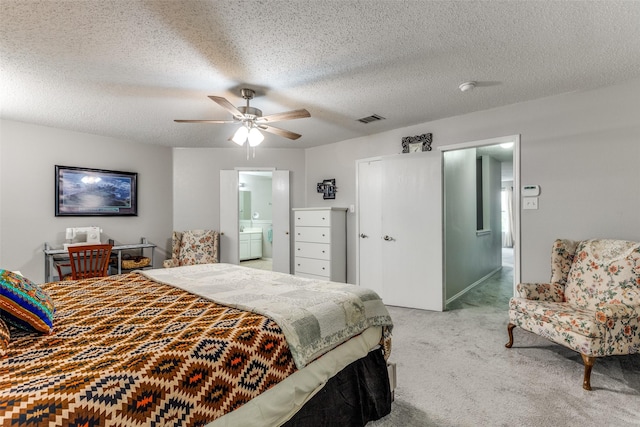 1017 Lake Trail Dr, Little Elm, TX 75068 - bedroom with carpet floors, a textured ceiling, connected bathroom, a closet, and a ceiling fan