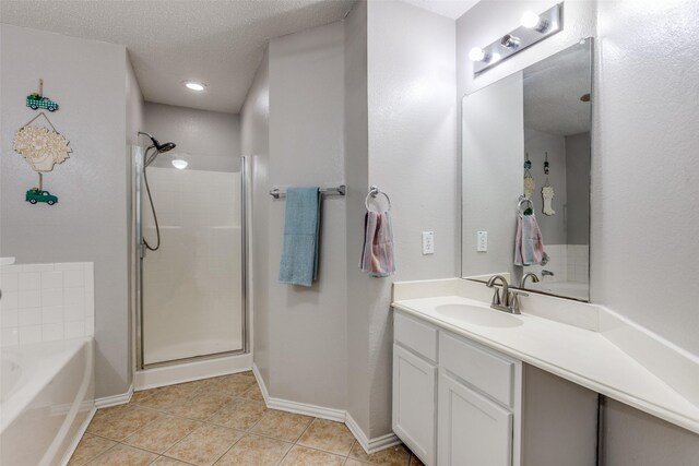 1017 Lake Trail Dr, Little Elm, TX 75068 - bathroom featuring a shower stall, vanity, tile patterned floors, a bath, and baseboards
