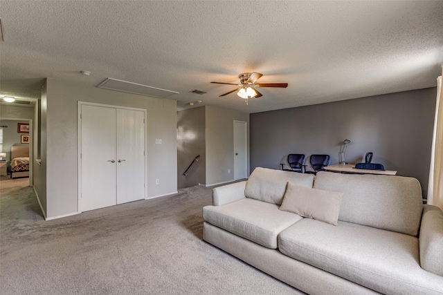 1017 Lake Trail Dr, Little Elm, TX 75068 - carpeted living room featuring attic access, a textured ceiling, and ceiling fan