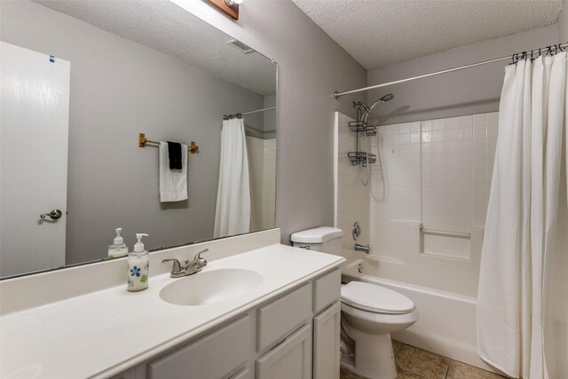 1017 Lake Trail Dr, Little Elm, TX 75068 - bathroom featuring vanity, shower / bath combo with shower curtain, toilet, a textured ceiling, and tile patterned floors