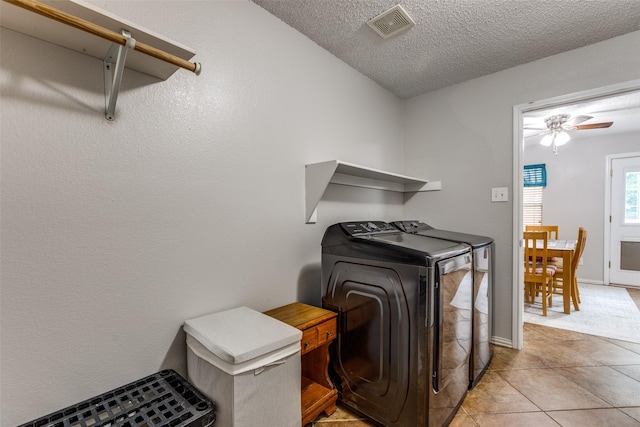 1017 Lake Trail Dr, Little Elm, TX 75068 - laundry area with washer and clothes dryer, a textured ceiling, light tile patterned floors, and ceiling fan