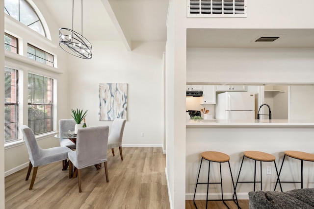 808 Brockden Dr, Mesquite, TX 75149 - dining space with light wood-style floors, a chandelier, and baseboards