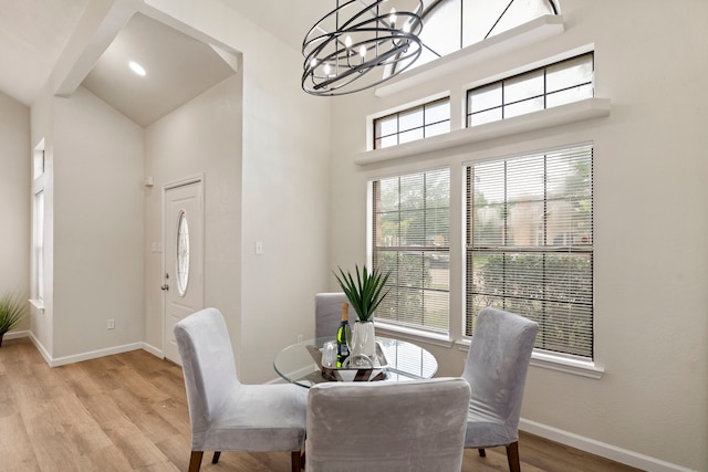 808 Brockden Dr, Mesquite, TX 75149 - dining room with wood finished floors, baseboards, a chandelier, and a towering ceiling
