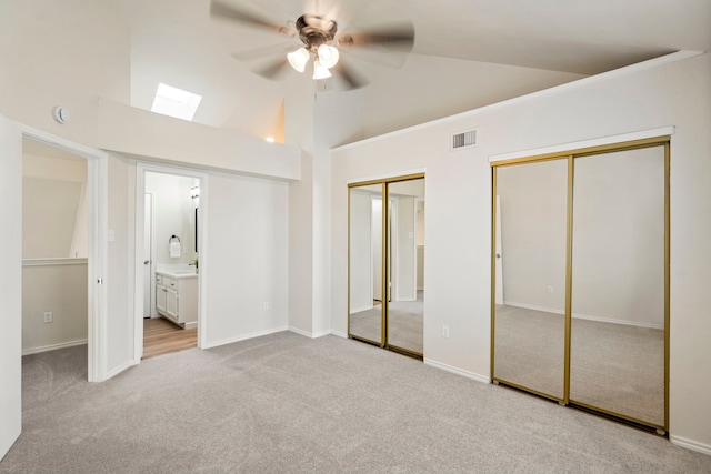 808 Brockden Dr, Mesquite, TX 75149 - unfurnished bedroom featuring two closets, carpet floors, a skylight, high vaulted ceiling, and baseboards