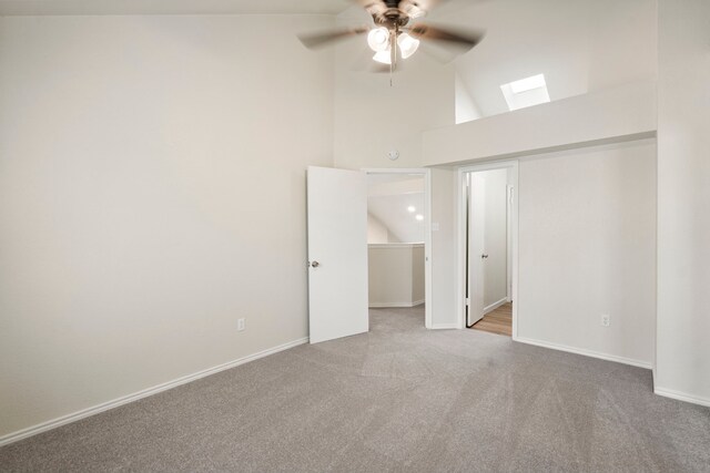 808 Brockden Dr, Mesquite, TX 75149 - unfurnished bedroom with a skylight, carpet floors, high vaulted ceiling, baseboards, and a ceiling fan