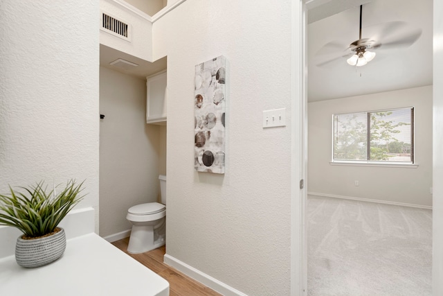 808 Brockden Dr, Mesquite, TX 75149 - bathroom with toilet, a ceiling fan, baseboards, wood finished floors, and a textured wall