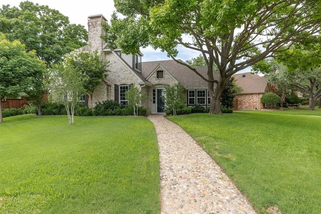 1401 Chesapeake Dr, Plano, TX 75093 - french country style house with a front yard, brick siding, and a chimney