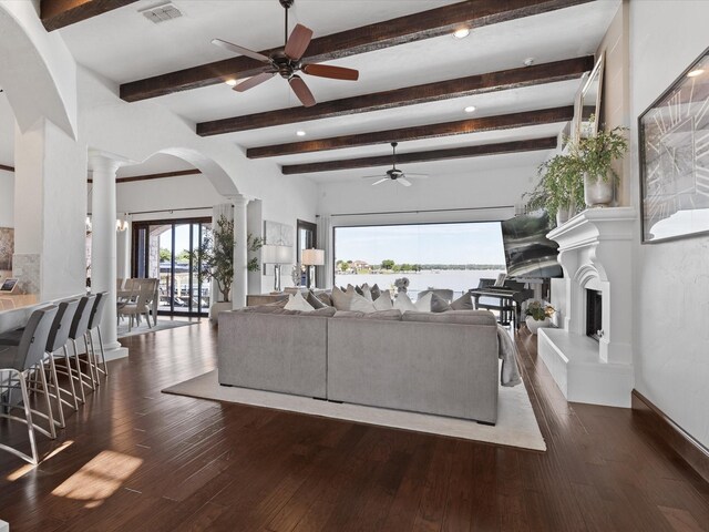 12633 Lakeview Ct, Fort Worth, TX 76179 - living room with ornate columns, ceiling fan, arched walkways, hardwood / wood-style flooring, and a fireplace with raised hearth