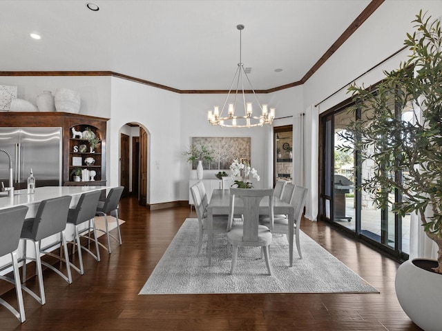 12633 Lakeview Ct, Fort Worth, TX 76179 - dining room with arched walkways, a chandelier, dark wood-style floors, ornamental molding, and baseboards