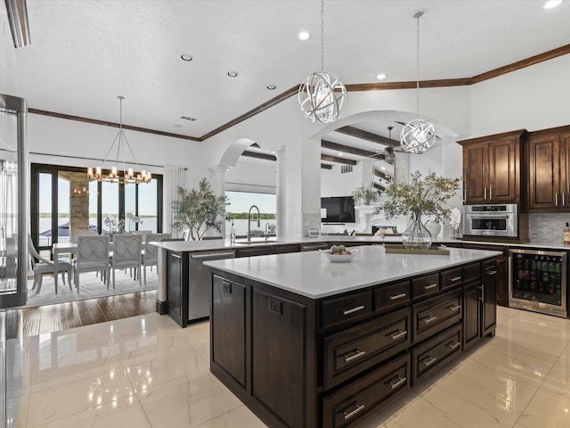 12633 Lakeview Ct, Fort Worth, TX 76179 - kitchen with beverage cooler, arched walkways, stainless steel appliances, crown molding, and a center island