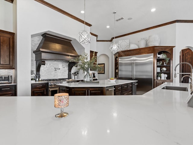 12633 Lakeview Ct, Fort Worth, TX 76179 - kitchen featuring high quality appliances, a sink, arched walkways, decorative backsplash, and crown molding