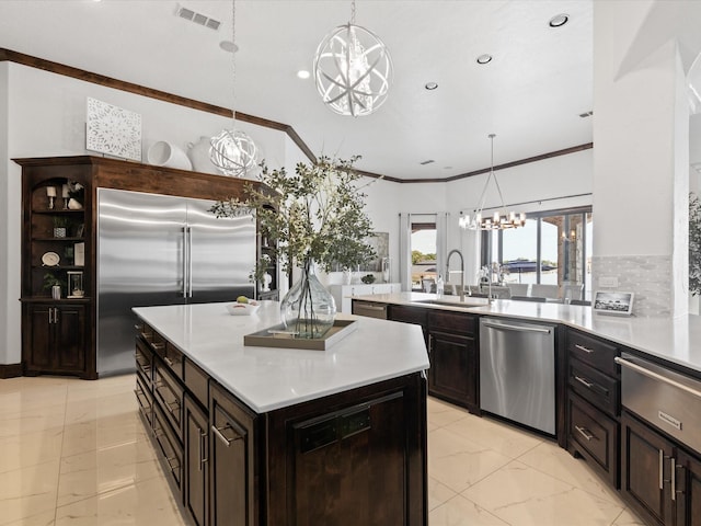 12633 Lakeview Ct, Fort Worth, TX 76179 - kitchen with a chandelier, stainless steel appliances, a sink, light countertops, and light marble finish flooring