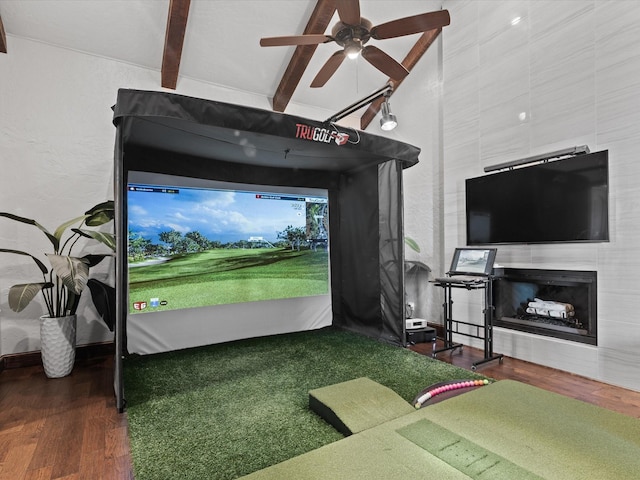 12633 Lakeview Ct, Fort Worth, TX 76179 - rec room with golf simulator, wood finished floors, ceiling fan, a fireplace, and a textured wall
