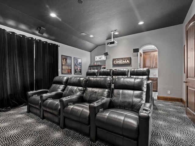 12633 Lakeview Ct, Fort Worth, TX 76179 - home theater with carpet flooring, arched walkways, vaulted ceiling, recessed lighting, and baseboards
