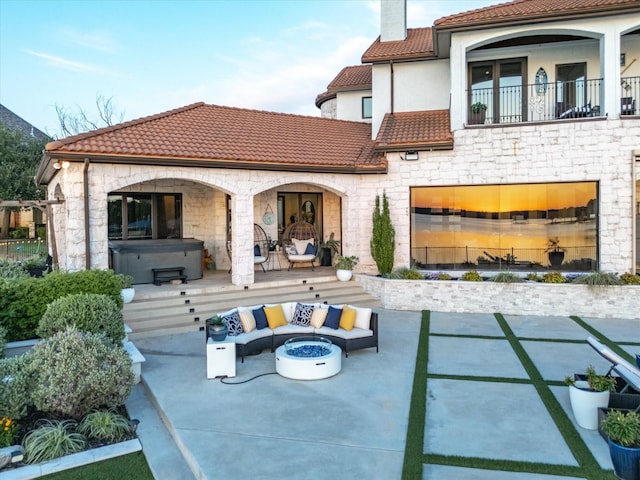 12633 Lakeview Ct, Fort Worth, TX 76179 - rear view of property with an outdoor living space with a fireplace, a tile roof, stone siding, and a hot tub