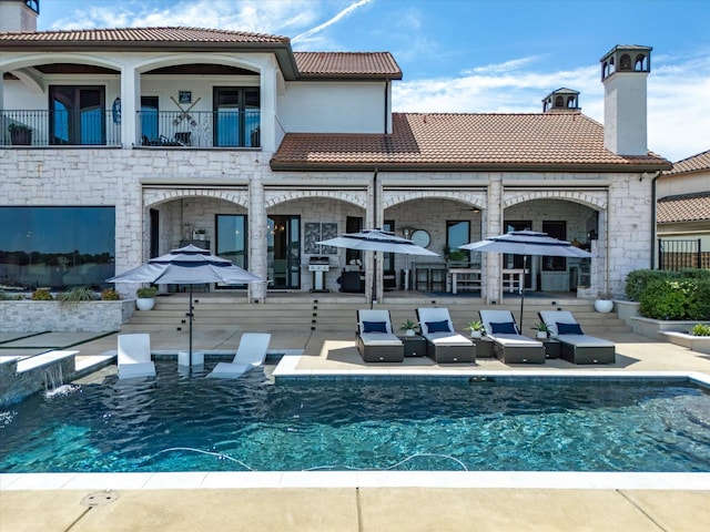 12633 Lakeview Ct, Fort Worth, TX 76179 - rear view of house featuring a tile roof, a chimney, a patio, and an outdoor pool