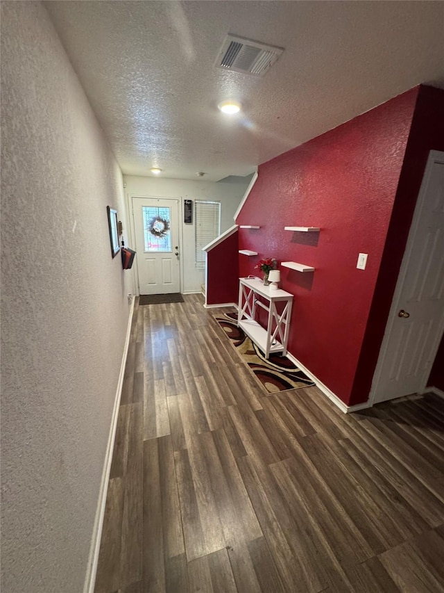 4331 Stetson Run, San Antonio, TX 78223 - hallway with a textured wall, a textured ceiling, wood finished floors, and baseboards