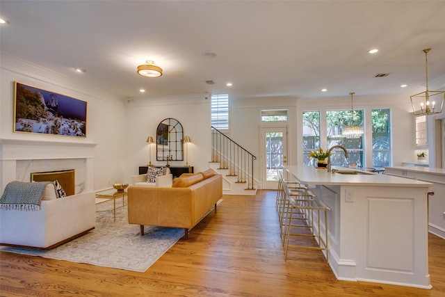 1360 Bent Trail Cir, Southlake, TX 76092 - living room featuring ornamental molding, stairs, light wood finished floors, a fireplace, and recessed lighting