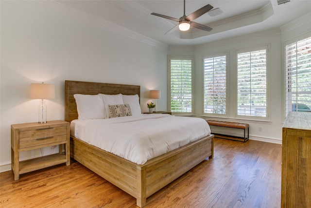 1360 Bent Trail Cir, Southlake, TX 76092 - bedroom featuring multiple windows, light wood-style flooring, ornamental molding, a tray ceiling, and a ceiling fan