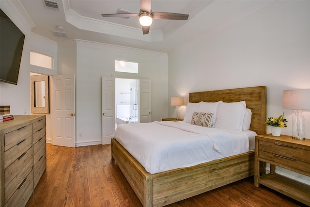 1360 Bent Trail Cir, Southlake, TX 76092 - bedroom featuring a tray ceiling, wood finished floors, ornamental molding, ceiling fan, and ensuite bath