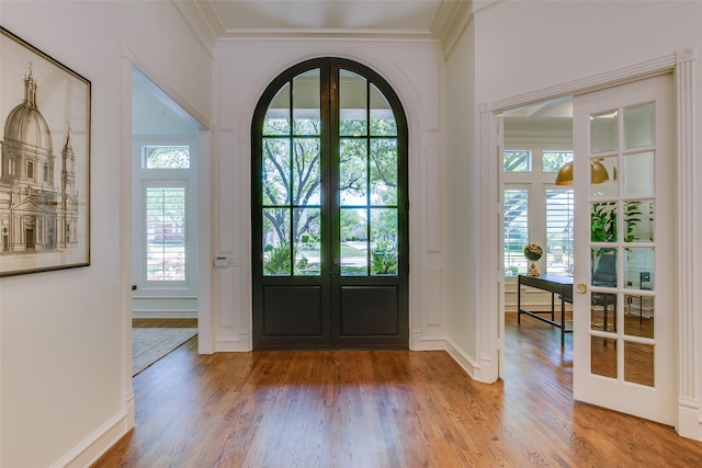1360 Bent Trail Cir, Southlake, TX 76092 - foyer entrance with french doors, crown molding, light wood finished floors, and arched walkways