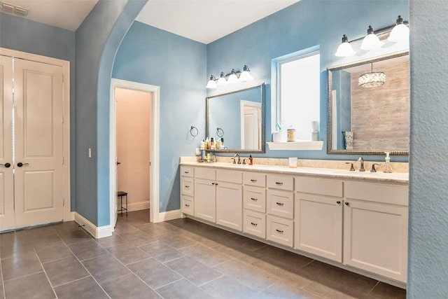 8051 Harliquin Ct, Frisco, TX 75035 - bathroom with double vanity and tile patterned flooring