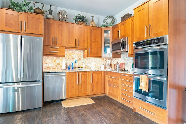 8051 Harliquin Ct, Frisco, TX 75035 - kitchen featuring appliances with stainless steel finishes, tasteful backsplash, and dark wood finished floors