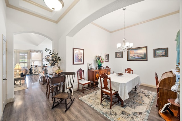 2109 County Road 4522, Justin, TX 76247 - dining room with arched walkways, ornamental molding, a high ceiling, wood finished floors, and a chandelier
