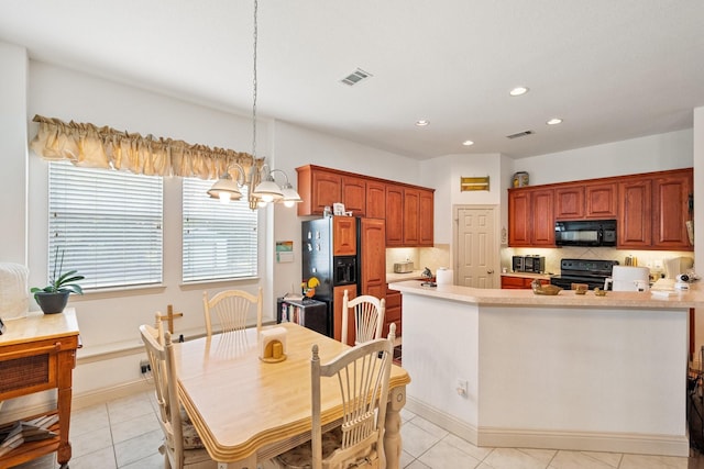 2109 County Road 4522, Justin, TX 76247 - kitchen featuring black appliances, light countertops, recessed lighting, and light tile patterned floors