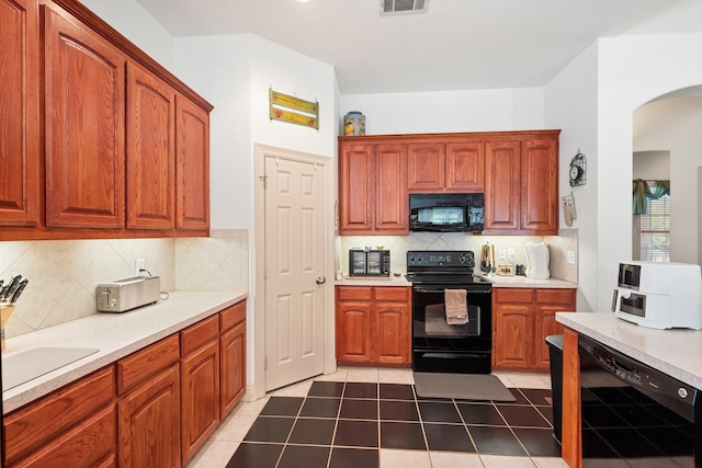 2109 County Road 4522, Justin, TX 76247 - kitchen with black appliances, arched walkways, light countertops, and tasteful backsplash