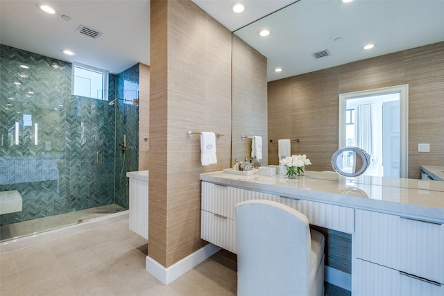 2828 Hood St Unit 1303, Dallas, TX 75219 - bathroom featuring double vanity, walk in shower, recessed lighting, tile walls, and tile patterned floors