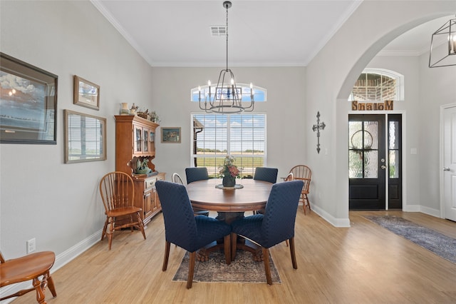 386 Frederick Dr, Robinson, TX 76706 - dining room featuring a chandelier, light wood finished floors, arched walkways, baseboards, and crown molding