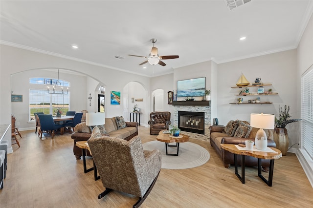 386 Frederick Dr, Robinson, TX 76706 - living room with arched walkways, light wood-type flooring, ceiling fan, a stone fireplace, and recessed lighting
