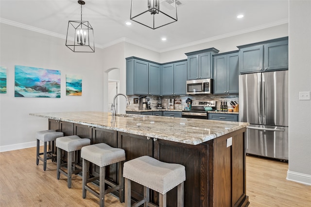 386 Frederick Dr, Robinson, TX 76706 - kitchen with appliances with stainless steel finishes, a sink, arched walkways, a chandelier, and light stone countertops