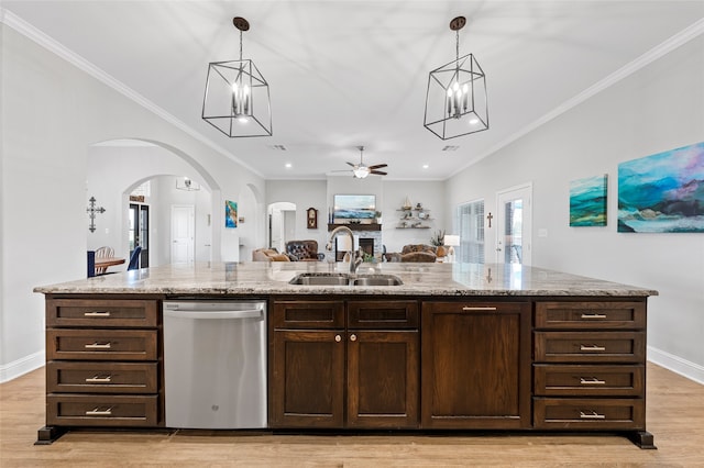 386 Frederick Dr, Robinson, TX 76706 - kitchen featuring dishwasher, a sink, arched walkways, ceiling fan, and light wood-style flooring