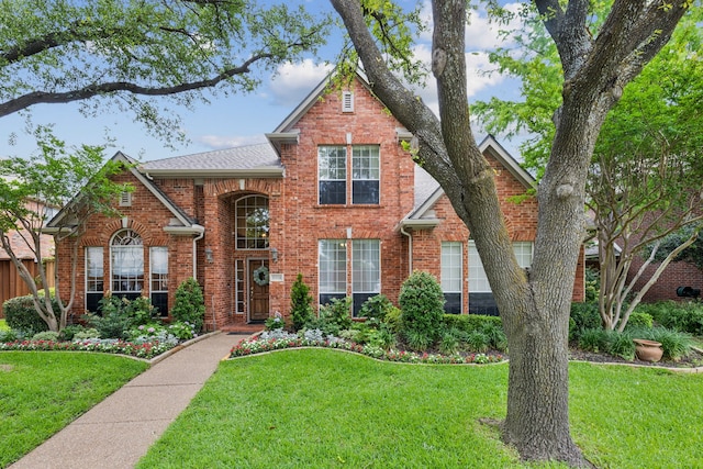 6305 Glenhollow Dr, Plano, TX 75093 - traditional-style home with brick siding, a front yard, and a shingled roof