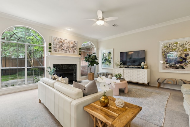 6305 Glenhollow Dr, Plano, TX 75093 - carpeted living room featuring ornamental molding, a ceiling fan, healthy amount of natural light, a fireplace, and baseboards