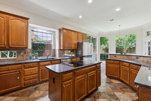 6305 Glenhollow Dr, Plano, TX 75093 - kitchen with freestanding refrigerator, ornamental molding, healthy amount of natural light, a sink, and tasteful backsplash