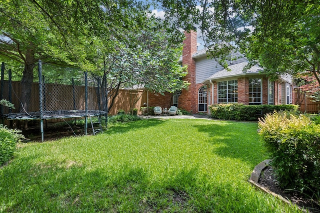 6305 Glenhollow Dr, Plano, TX 75093 - view of yard with a trampoline and a patio area