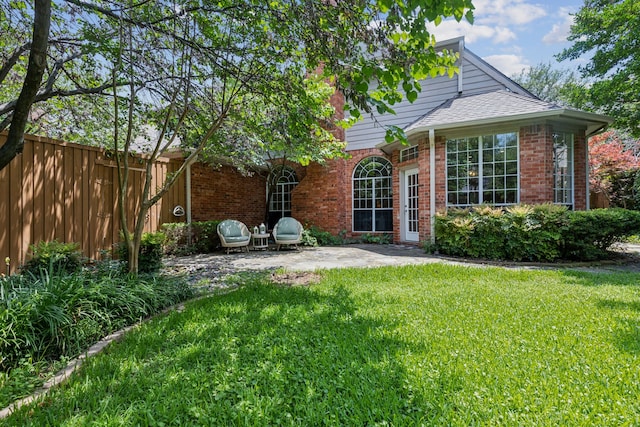 6305 Glenhollow Dr, Plano, TX 75093 - back of house with brick siding and a patio