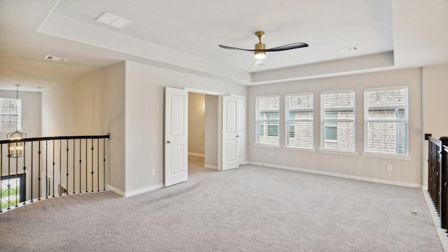 15270 Catalpa Rd, Frisco, TX 75035 - carpeted spare room with ceiling fan, baseboards, a raised ceiling, and a chandelier