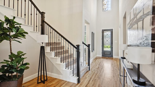 15270 Catalpa Rd, Frisco, TX 75035 - entryway with a towering ceiling, wood finished floors, stairway, and baseboards